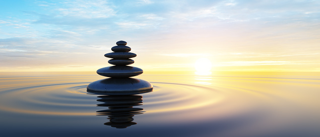 Stack of Stones in calm water with evening clouds